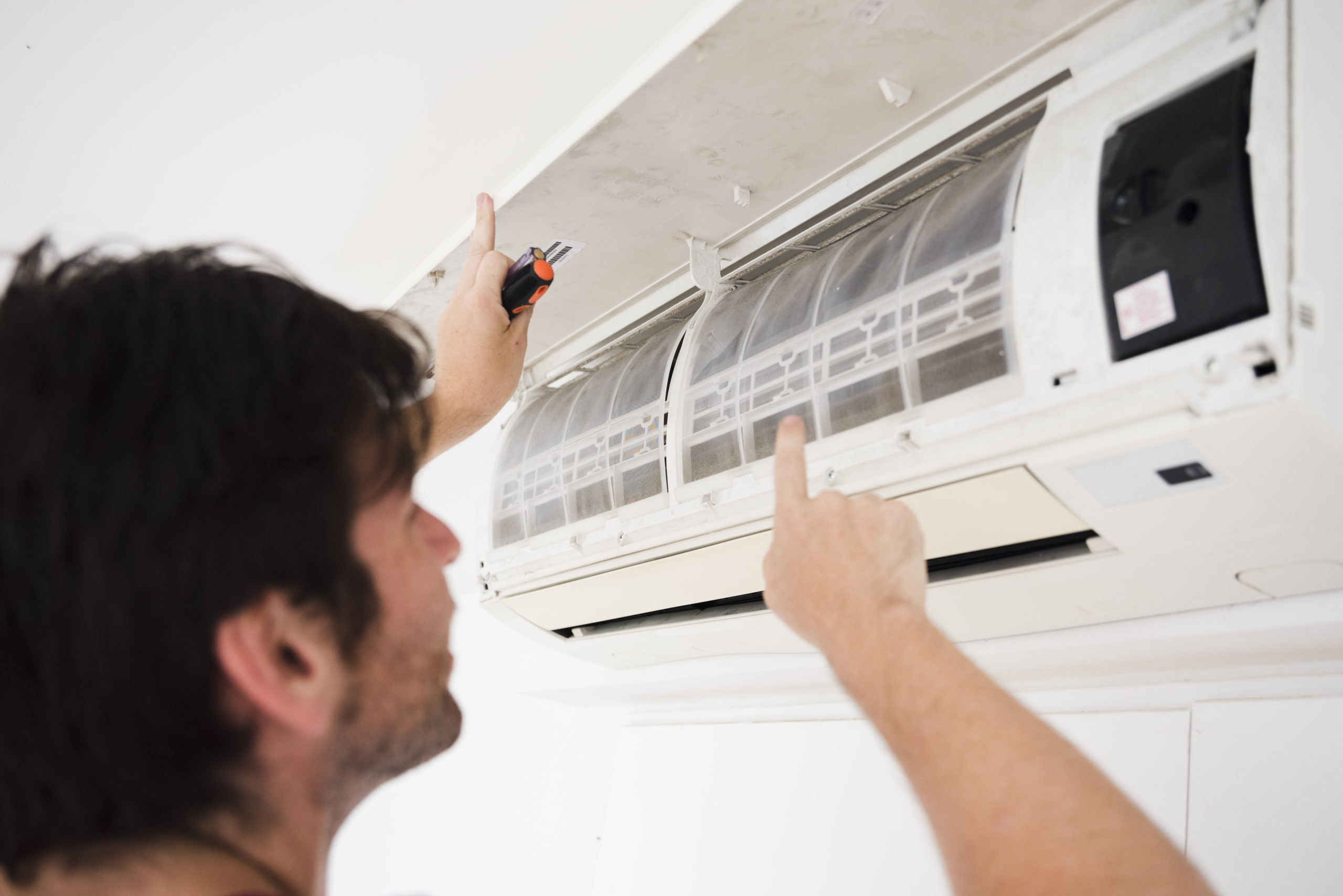 close up electrician repairing air conditioner