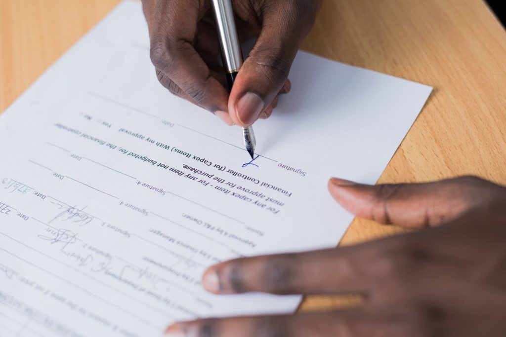 A person going through warranty paperwork, which is something you need to do when you buy your kitchen appliances abroad.