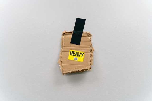 a cardboard piece saying heavy