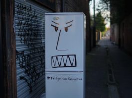 A fridge with an angry face drawn on it