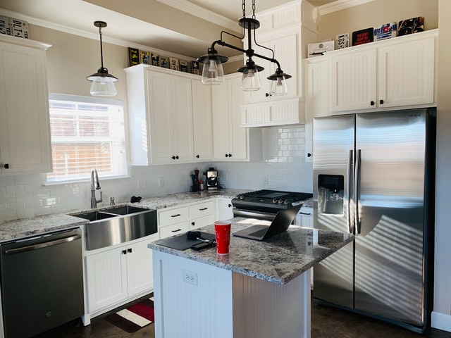 A side-by-side fridge in a small kitchen.