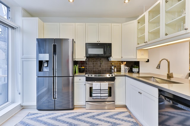 A kitchen that shows pros and cons of side-by-side refrigerators.